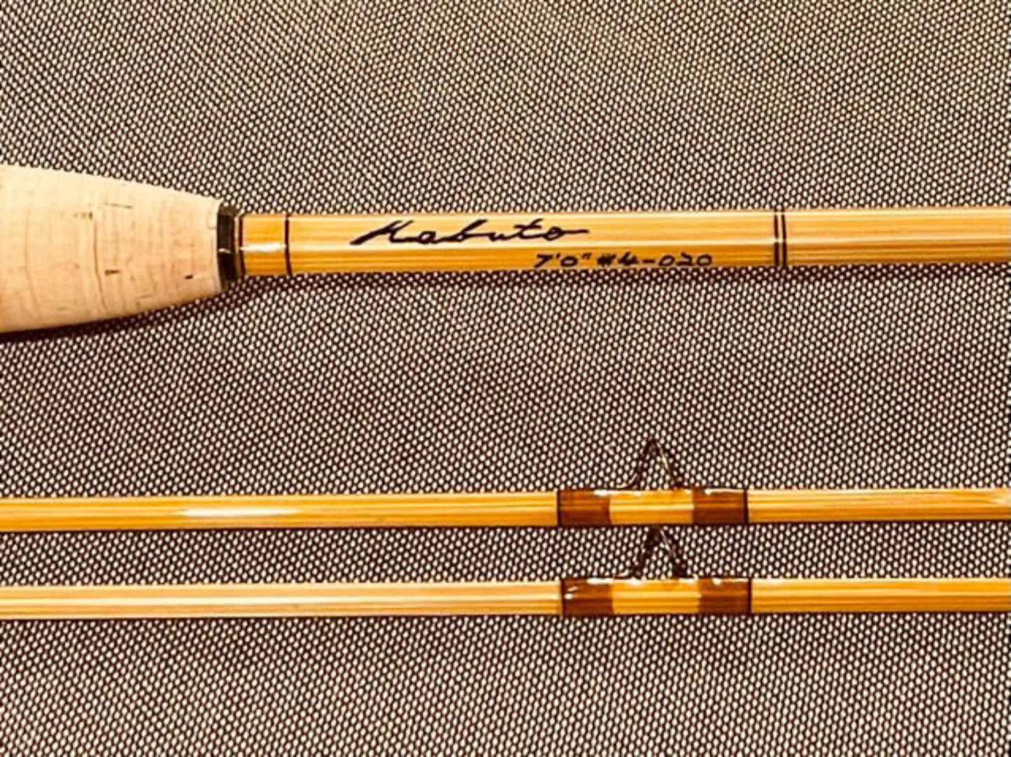 Fishing rod components on a textured gray background