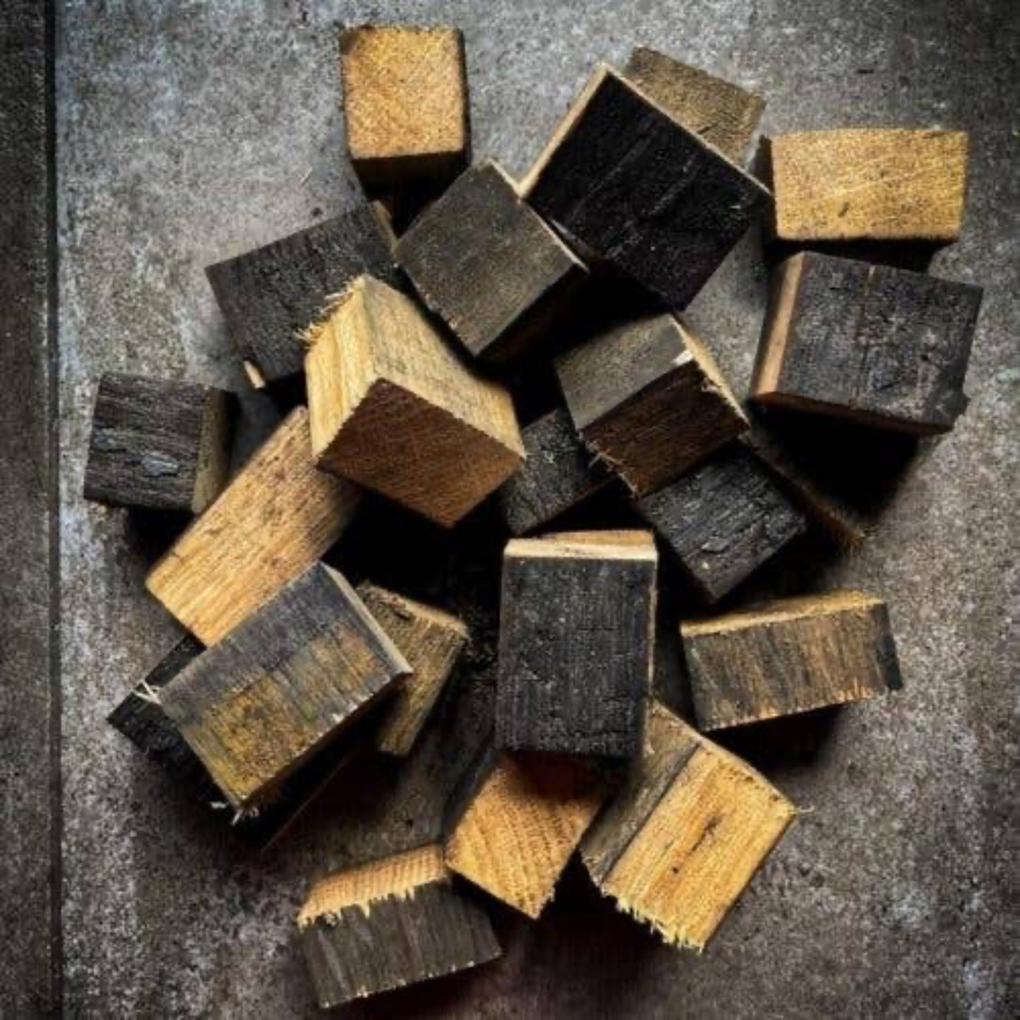 Stack of dark stave blocks on a textured surface