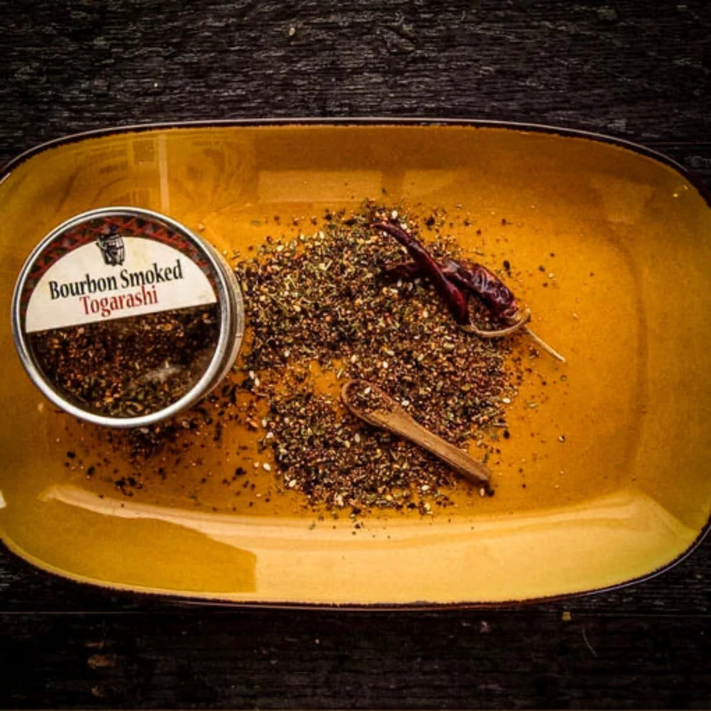 Overhead view of Bourbon Smoked Togarashi spice tin showing the full product packaging and branding