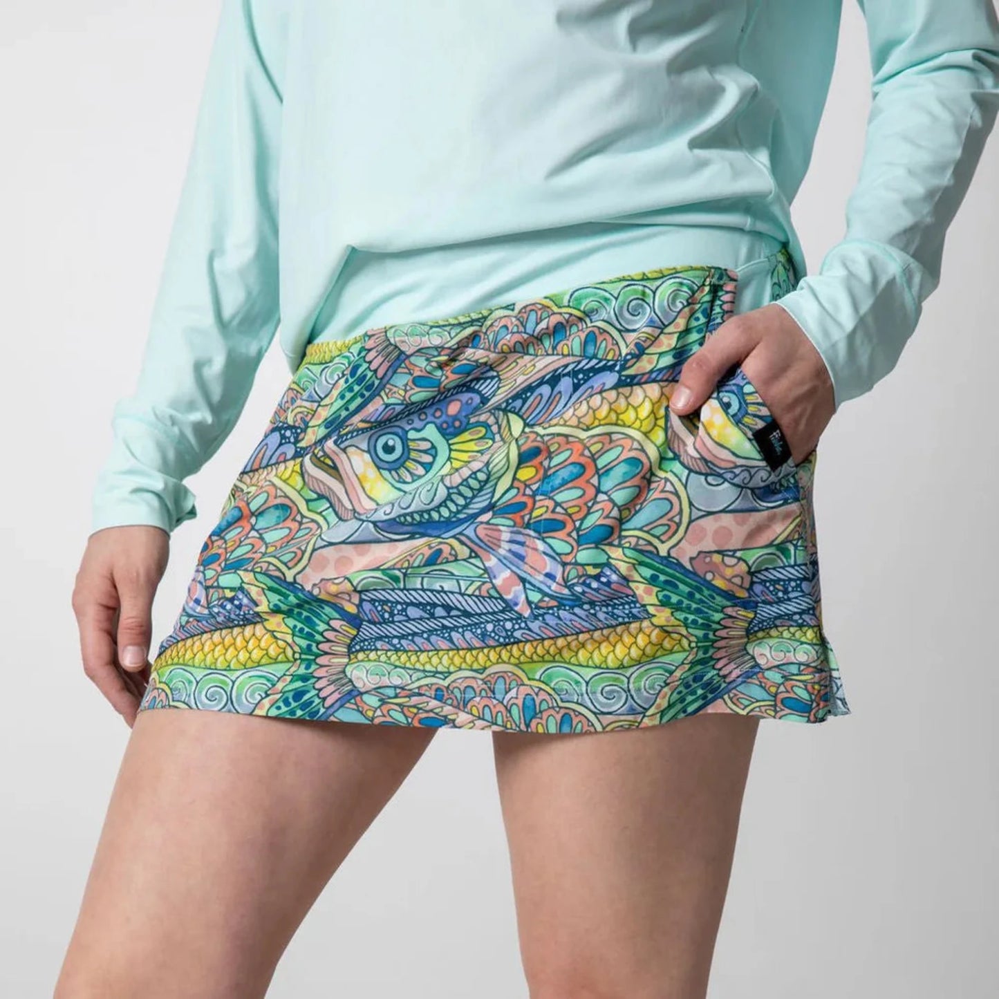 Side view of Tropical Tarpon Ravine Skort highlighting the skort's length, pockets, and athletic silhouette