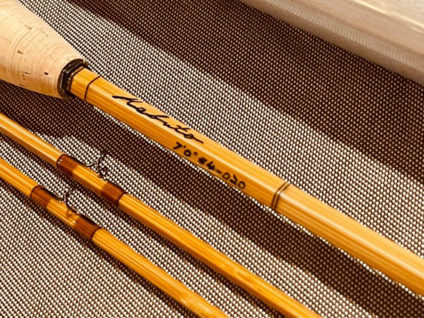 Close-up of a fishing rod with 'Lefroy' branding on a textured background