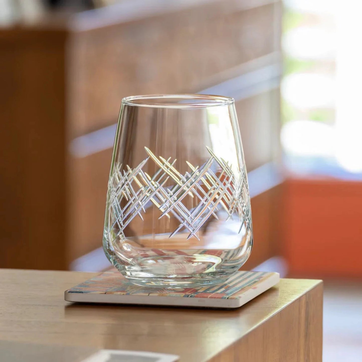 Experience the elegance of the Argyle 15.75oz Stemless Wine Glass, a timeless design inspired by the tartans of the Clan Cambell of Argyll, Scotland in the 17th century. This classic diamond pattern became an iconic symbol of British fashion after the Duke of Windsor adopted it in the 1920s. Crafted by Rolf Glass, each piece is a testament to the enduring appeal of the Argyle pattern. Elevate your wine tasting experience with this sophisticated and stylish wine glass.