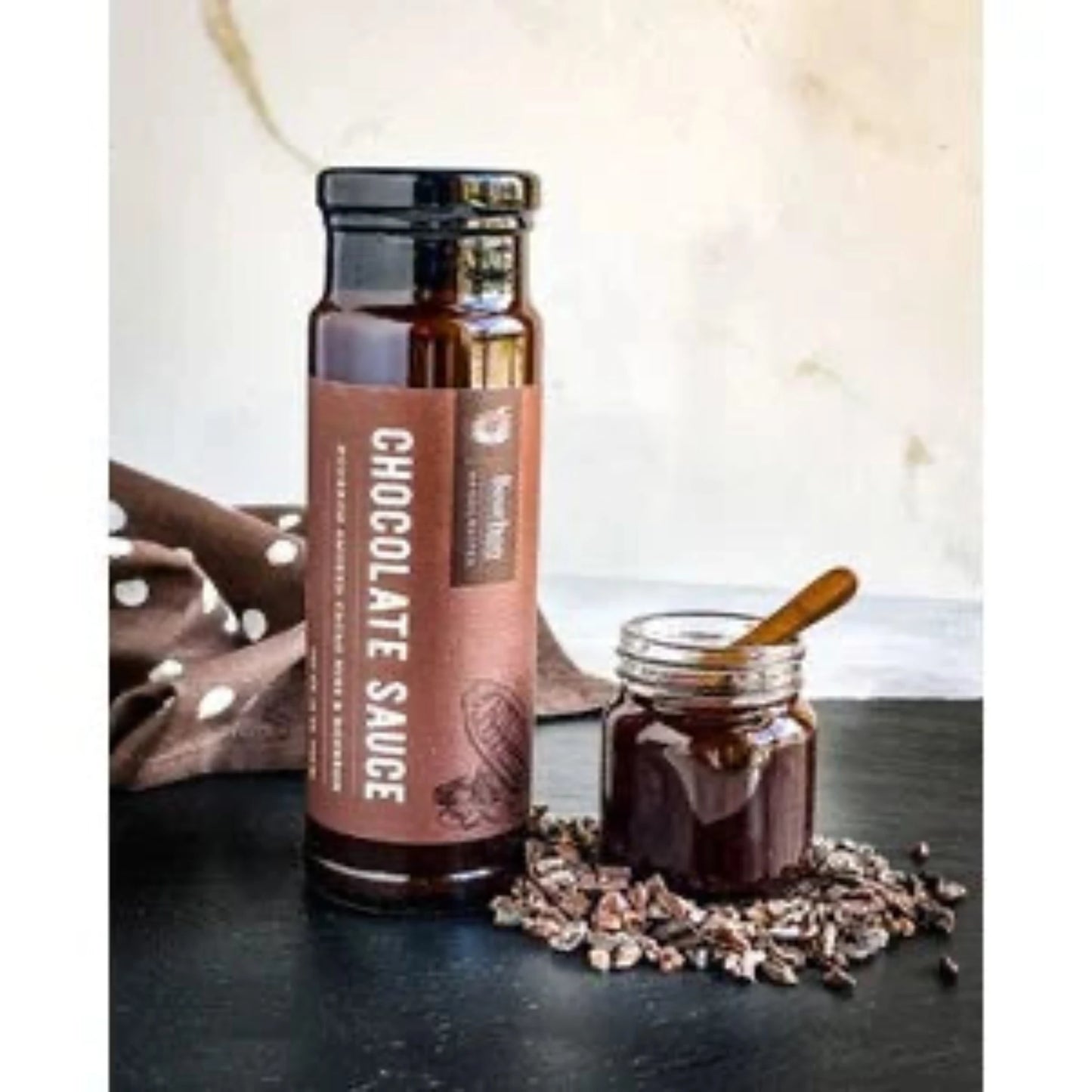 Bourbon Smoked Cacao Nibs infuse this signature Chocolate Sauce with a delightful texture. It’s a harmonious blend of creaminess and crunchiness, complemented by its rich and bittersweet flavor. Indulge in this decadent treat by spooning it over ice cream or drizzling it on your favorite fruits.