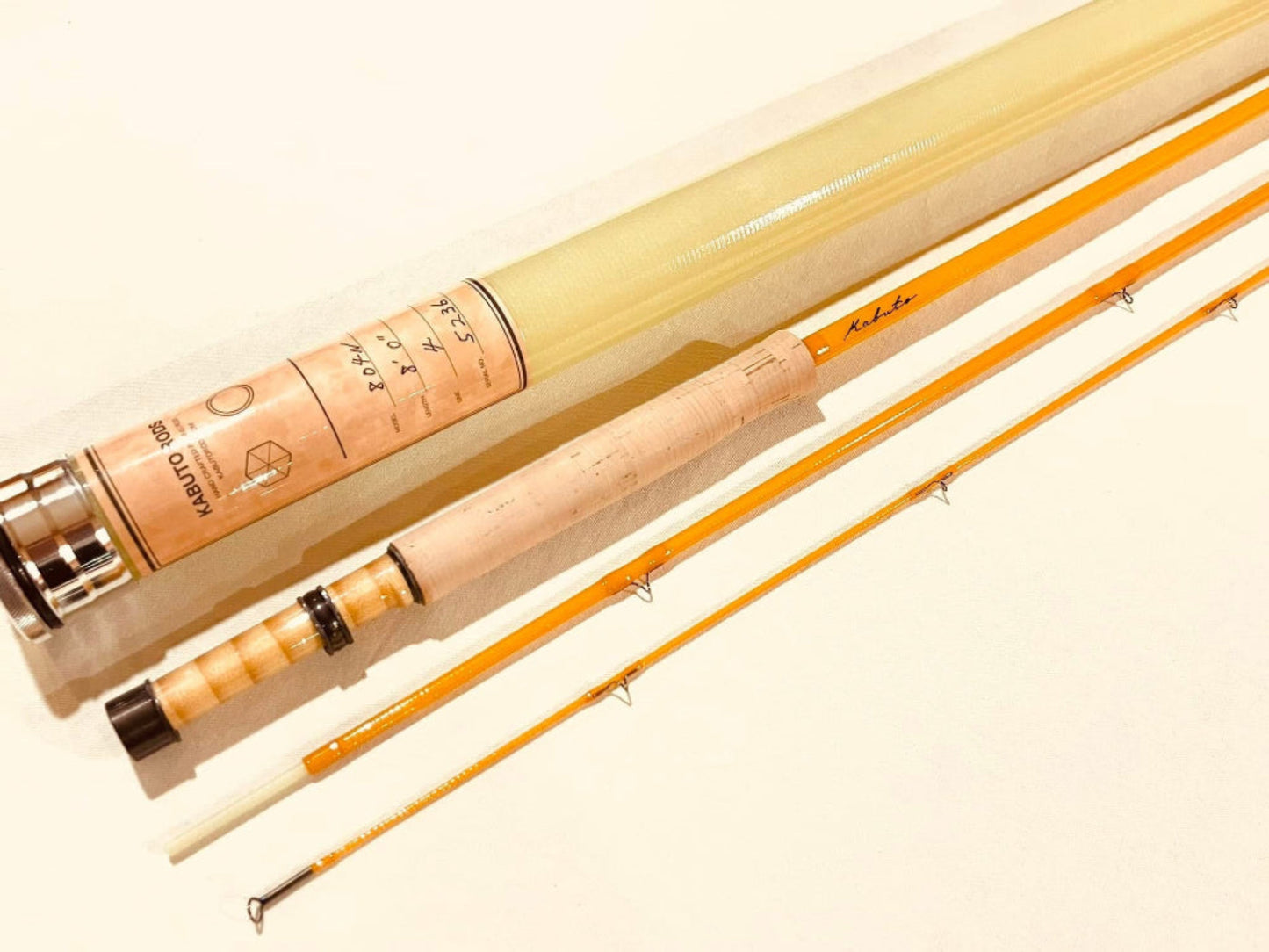 A precision-crafted yellow fly rod, 8 feet in length, designed for expert anglers. The rod features a stacked bamboo reel seat, adding a classic touch to its fiberglass construction. Its moderate action and light power offer smooth casting for fly fishing enthusiasts.