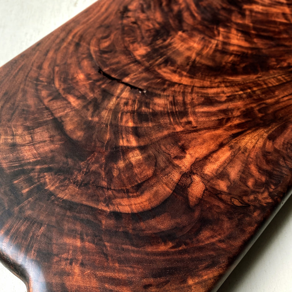 This Handcrafted Charcuterie Board is fashioned from Highly Figured Walnut wood from the Northeastern States. Its generously sized design, measuring 22