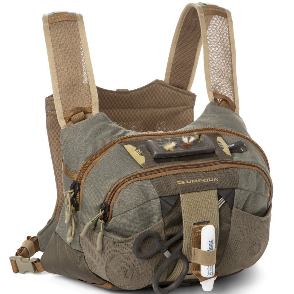 A green chest pack with multiple pockets and straps, designed for fishing and outdoor activities.