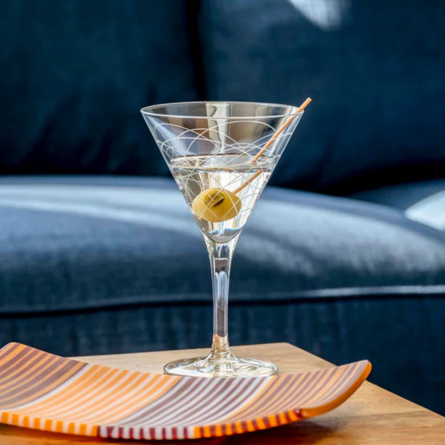 Step back in time with our Mid-Century Modern 7.5oz Martini Cocktail Glass. Crafted with the finest materials and featuring unique geometric designs inspired by the iconic mid-century modern era, this glass is the perfect vessel for your favorite cocktails. Whether you prefer your martini shaken or stirred, this glass adds a touch of retro elegance to any bar or table setting. Made in the USA and dishwasher safe, it's the perfect addition to your cocktail collection.