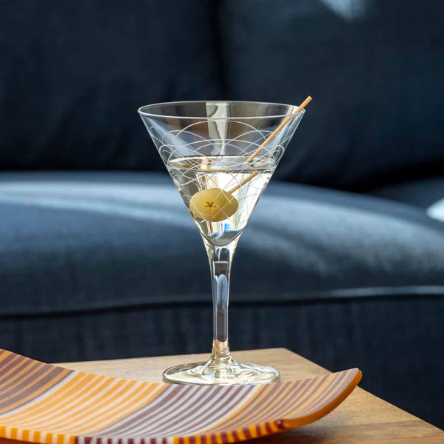 Step back in time with our Mid-Century Modern 7.5oz Martini Cocktail Glass. Crafted with the finest materials and featuring unique geometric designs inspired by the iconic mid-century modern era, this glass is the perfect vessel for your favorite cocktails. Whether you prefer your martini shaken or stirred, this glass adds a touch of retro elegance to any bar or table setting. Made in the USA and dishwasher safe, it's the perfect addition to your cocktail collection.