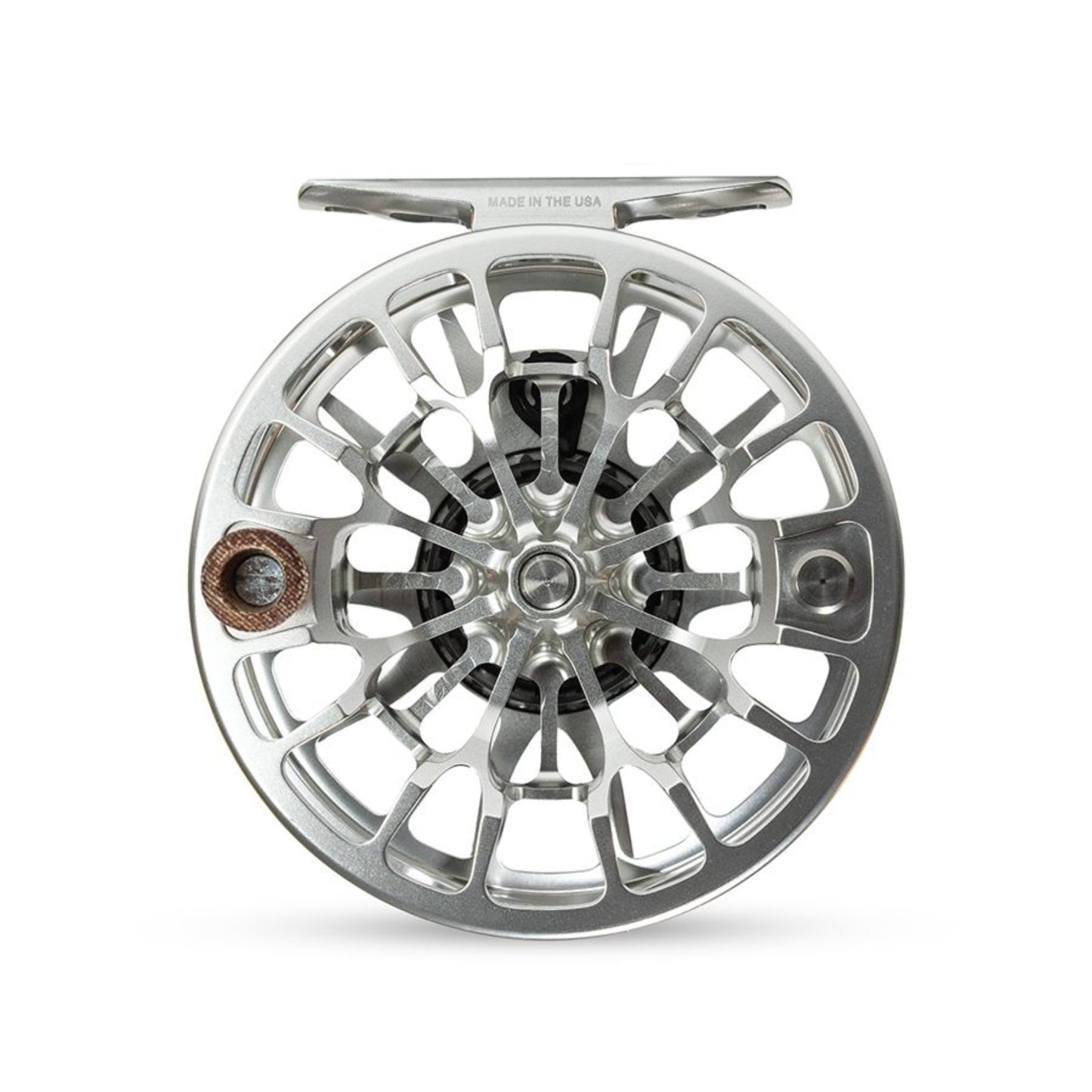Silver fly fishing reel on a white background