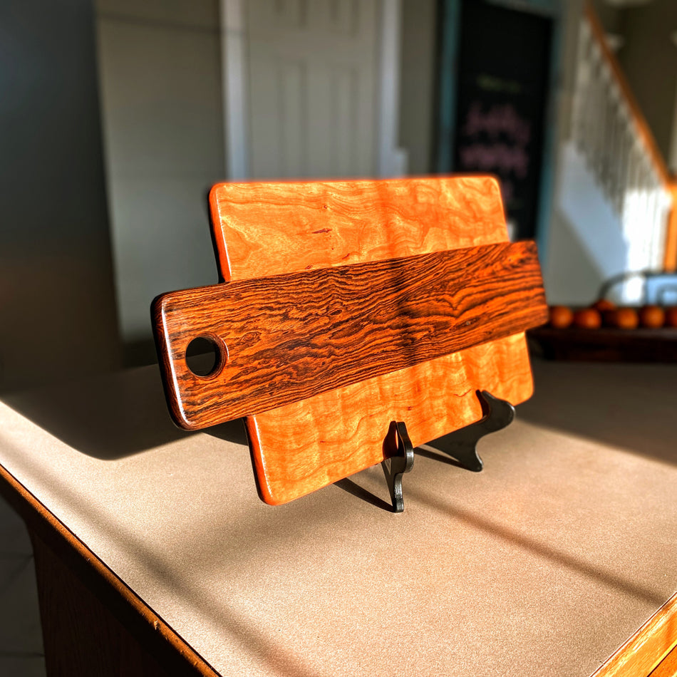 This Charcuterie Board has been expertly handcrafted with Bocote and Curly Cherry, measuring 21