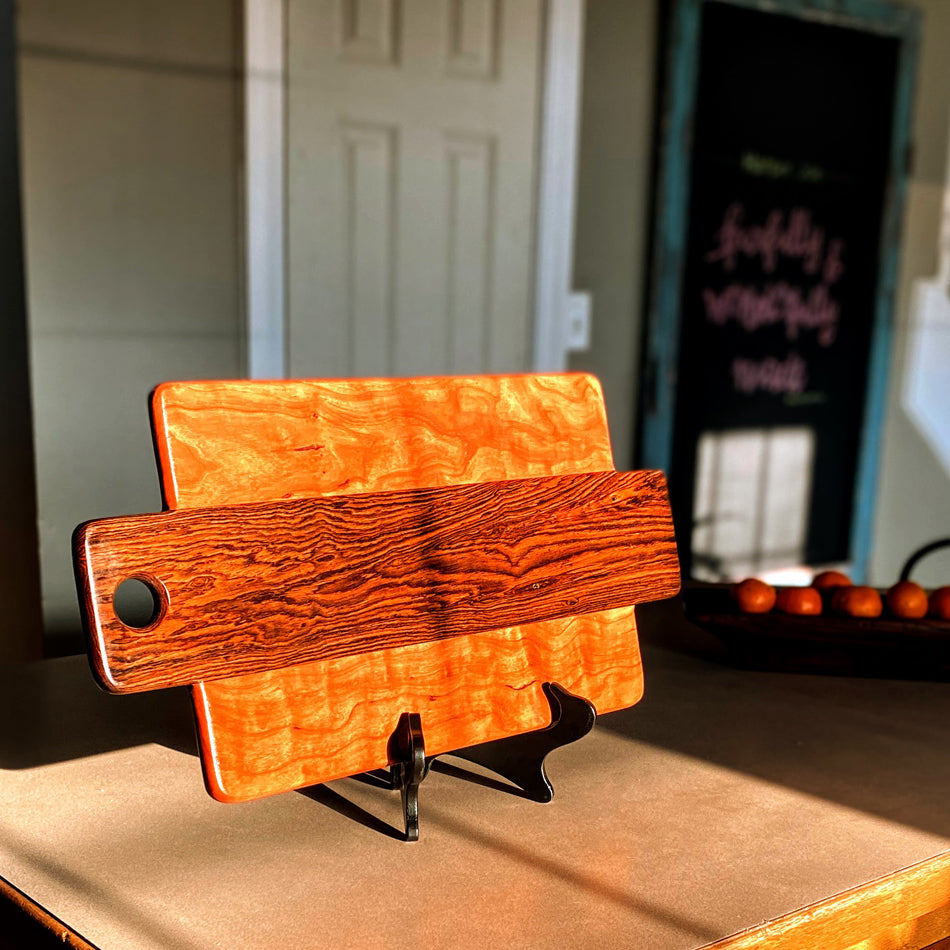 This Charcuterie Board has been expertly handcrafted with Bocote and Curly Cherry, measuring 21