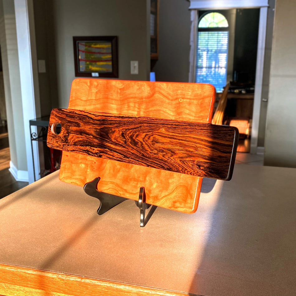 This Charcuterie Board has been expertly handcrafted with Bocote and Curly Cherry, measuring 21