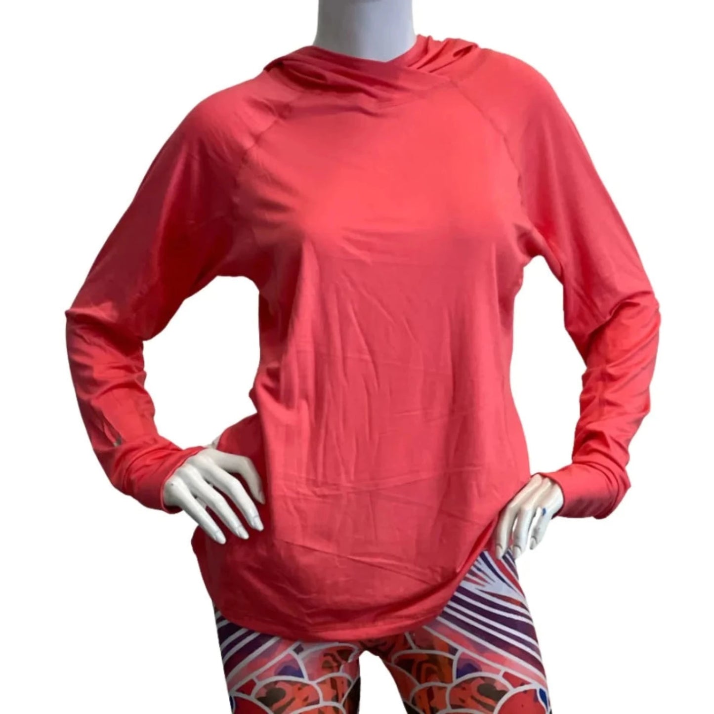 Woman wearing coral Stonefly Sunshirt UPF 50+ hoodie outdoors for sun protection