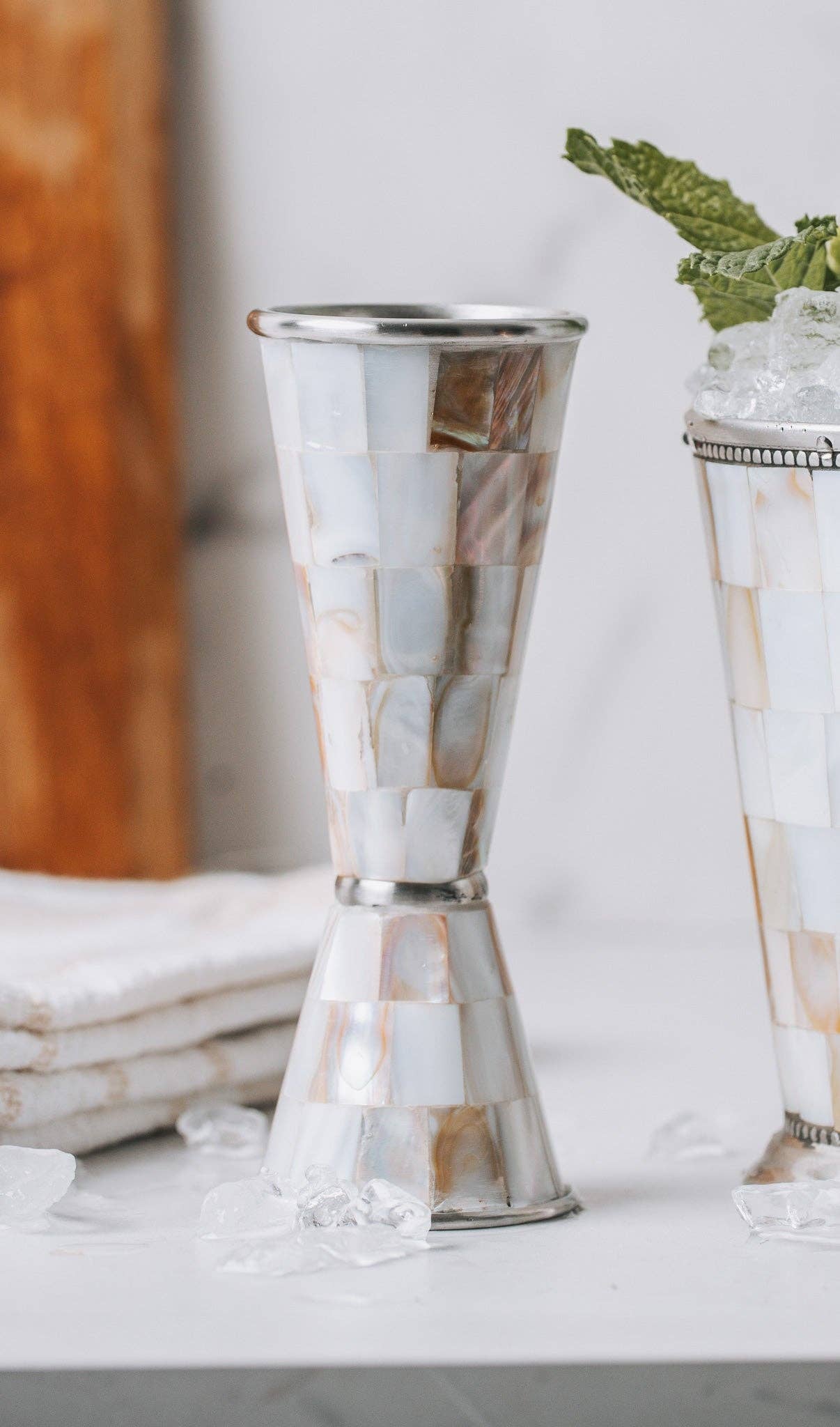 Marbled cocktail shaker on a white surface with a blurred background