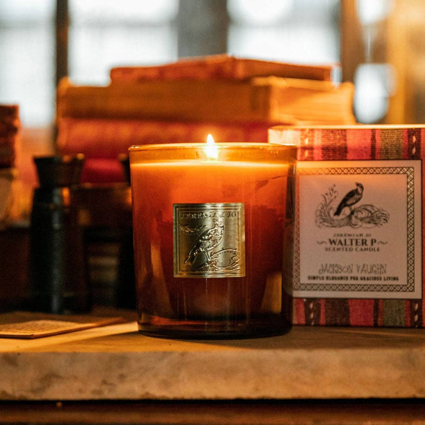 Candle with a decorative label on a wooden surface