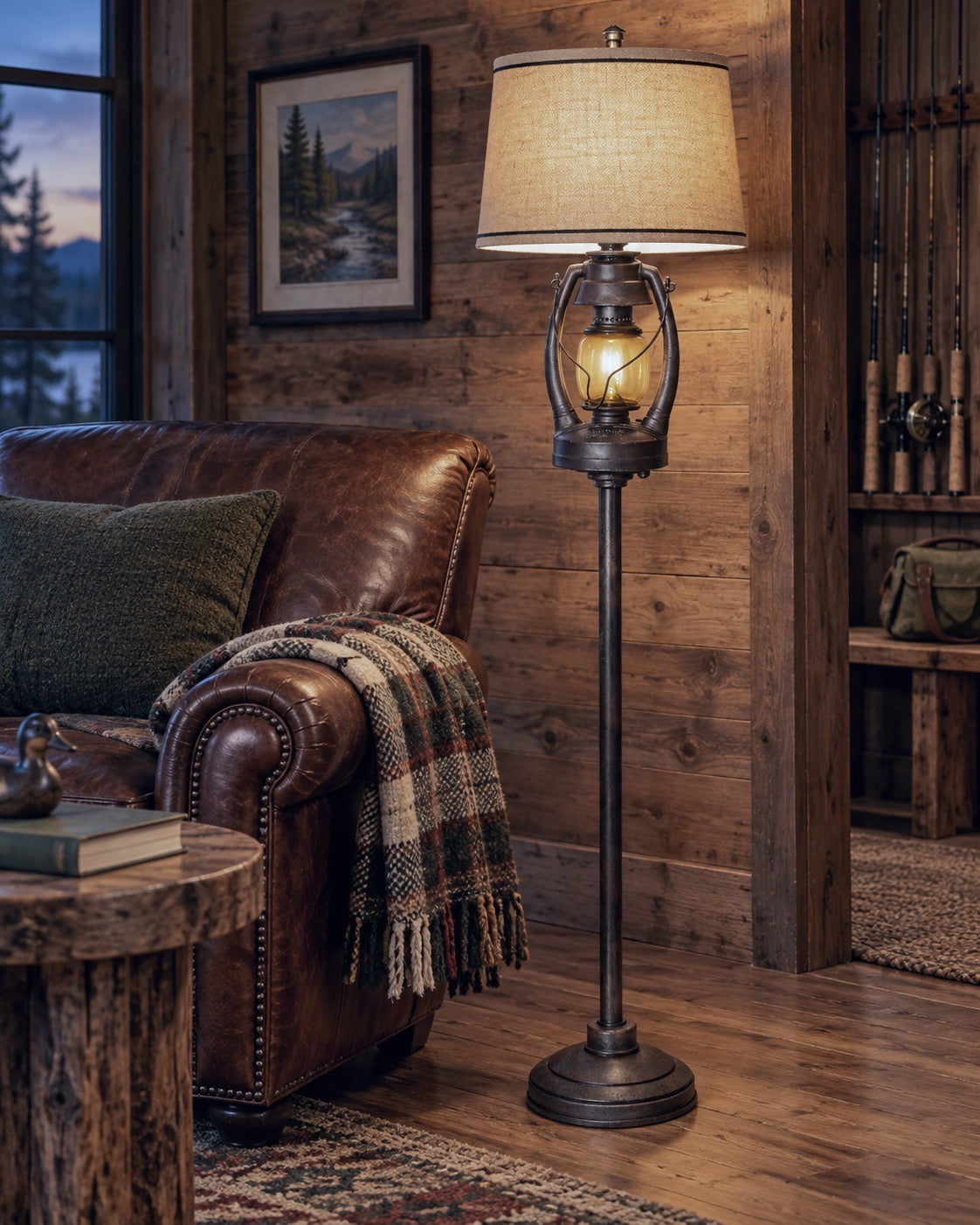 A rustic floor lamp with a warm glowing lantern-style shade and dark metal stand, placed beside a brown leather armchair in a cozy wood-paneled room.