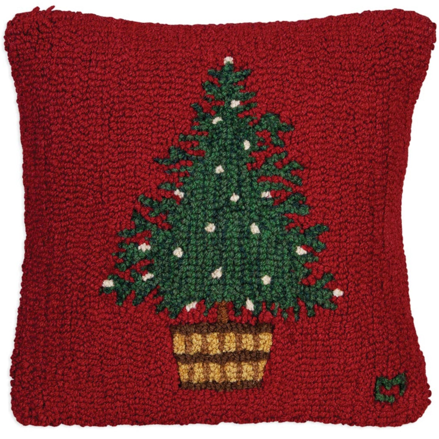 Red pillow with a Christmas tree design on a white background