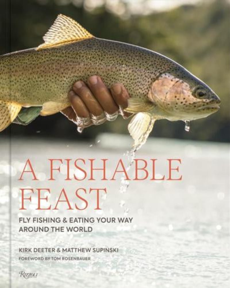 Book cover of 'A Fishable Feast' with a hand holding a fish and water droplets.