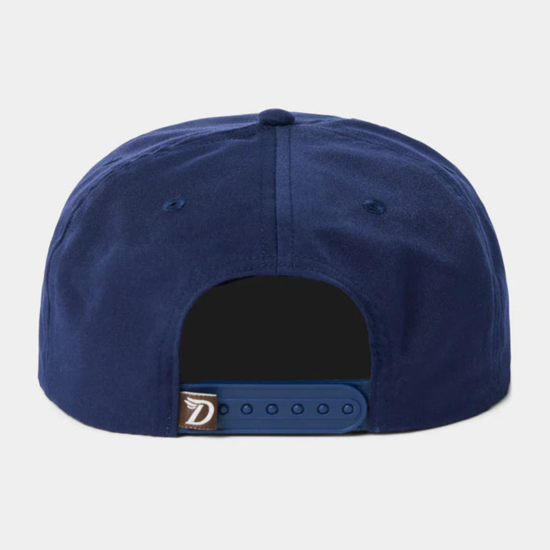The back of a navy blue snapback cap on a light gray background, featuring a dark navy curved brim and a small metallic logo patch on the side.