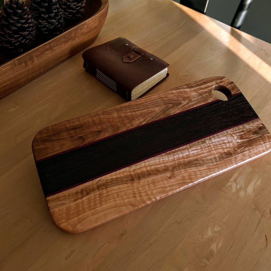 
                  
                    This eye-catching Charcuterie Board crafted from Tiger Heart Curly Maple, Purple Heart and Wenge adds a stylish touch to every tabletop. Make a lasting impression on your colleagues at the next get-together with this elegant serving board
                  
                
