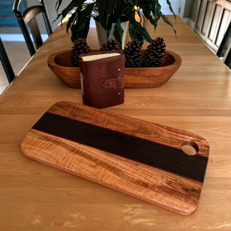 This eye-catching Charcuterie Board crafted from Tiger Heart Curly Maple, Purple Heart and Wenge adds a stylish touch to every tabletop. Make a lasting impression on your colleagues at the next get-together with this elegant serving board