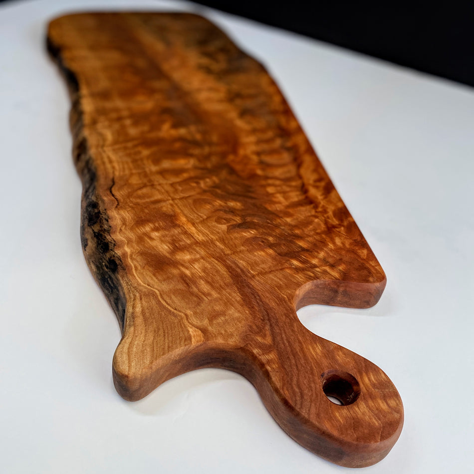 
                  
                    This Board is crafted with Live Edge Quilted Maple, featuring intricate detail to maintain its live edge, elegance and striking grain. Quilted Maple is remarkable, showcasing an abundance of captivating colors and ample space, perfect for displaying an exquisite charcuterie board.
                  
                