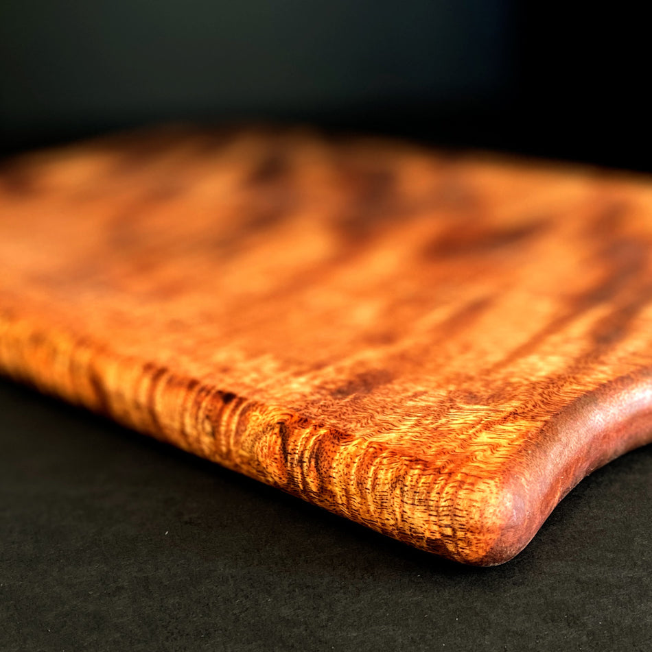 
                  
                    This Board was crafted from Curly Mango and displays a live edge with intricate detailing to retain its character and luster. The Curly Mango's captivating colors are awe-inspiring and abundant surface area to create an incredible charcuterie board.
                  
                