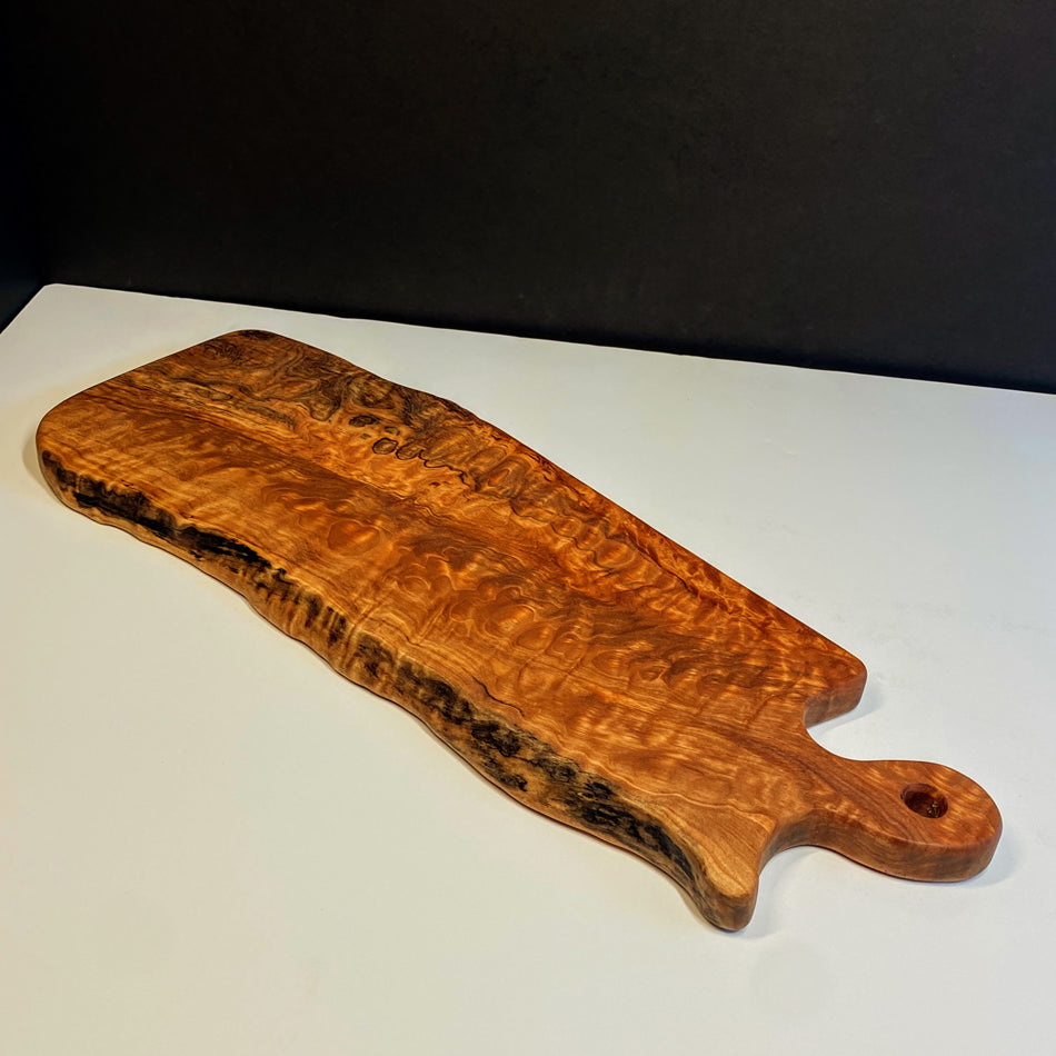 
                  
                    This Board is crafted with Live Edge Quilted Maple, featuring intricate detail to maintain its live edge, elegance and striking grain. Quilted Maple is remarkable, showcasing an abundance of captivating colors and ample space, perfect for displaying an exquisite charcuterie board.
                  
                