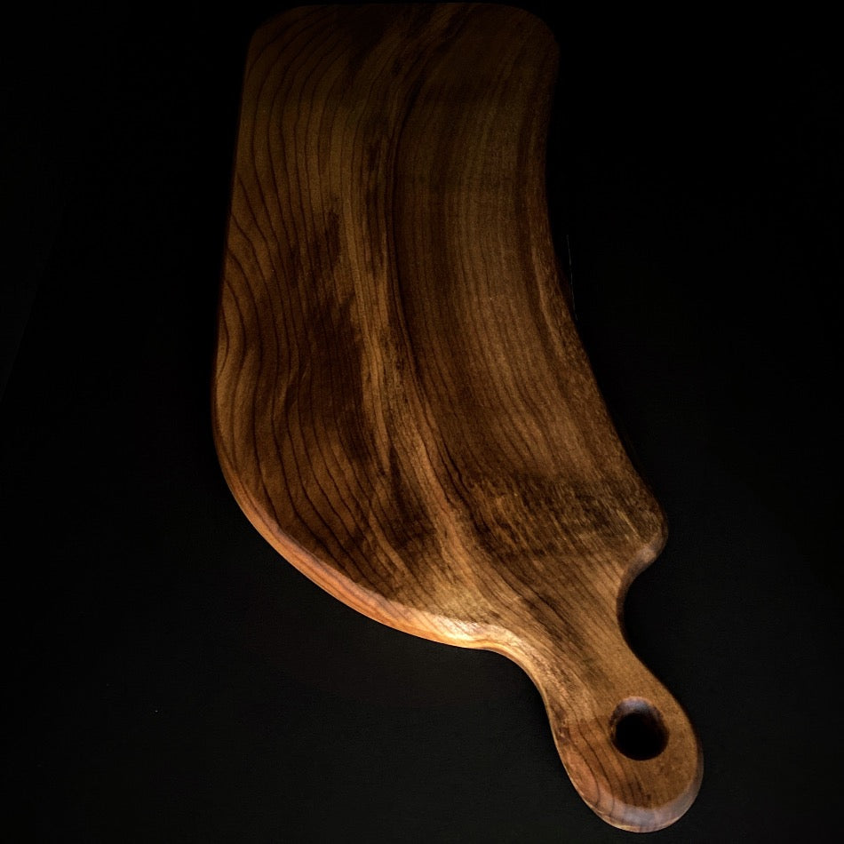 
                  
                    This handcrafted Charcuterie Board was crafted with gorgeous Myrtle wood. This particular piece is live edge and has amazing colors with curling towards the handle. Ideal for intimate social gatherings.  It is not recommended as a cutting board 
                  
                
