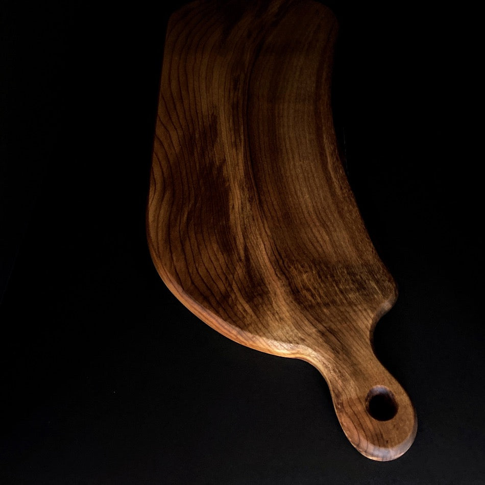
                  
                    This handcrafted Charcuterie Board was crafted with gorgeous Myrtle wood. This particular piece is live edge and has amazing colors with curling towards the handle. Ideal for intimate social gatherings.  It is not recommended as a cutting board 
                  
                