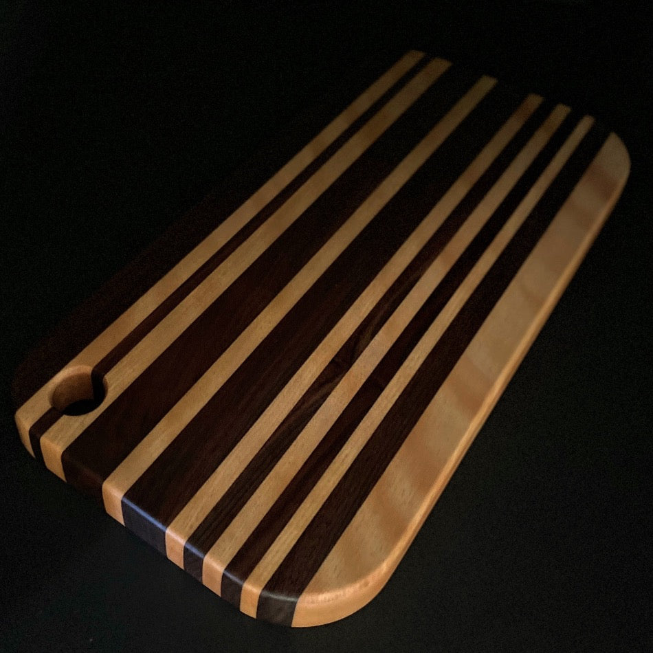 This awesome serving board or bread board is Handcrafted with Walnut & Curley Cherry. 