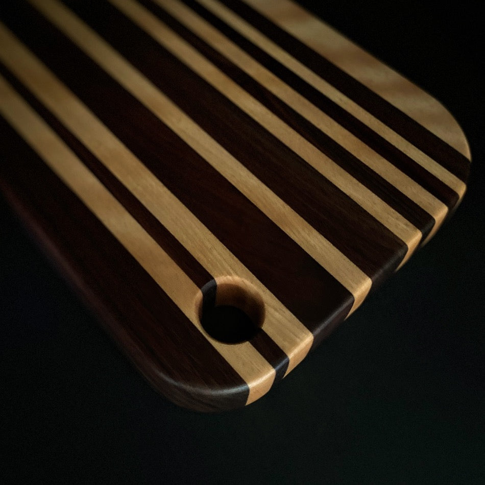 
                  
                    This awesome serving board or bread board is Handcrafted with Walnut & Curley Cherry. 
                  
                