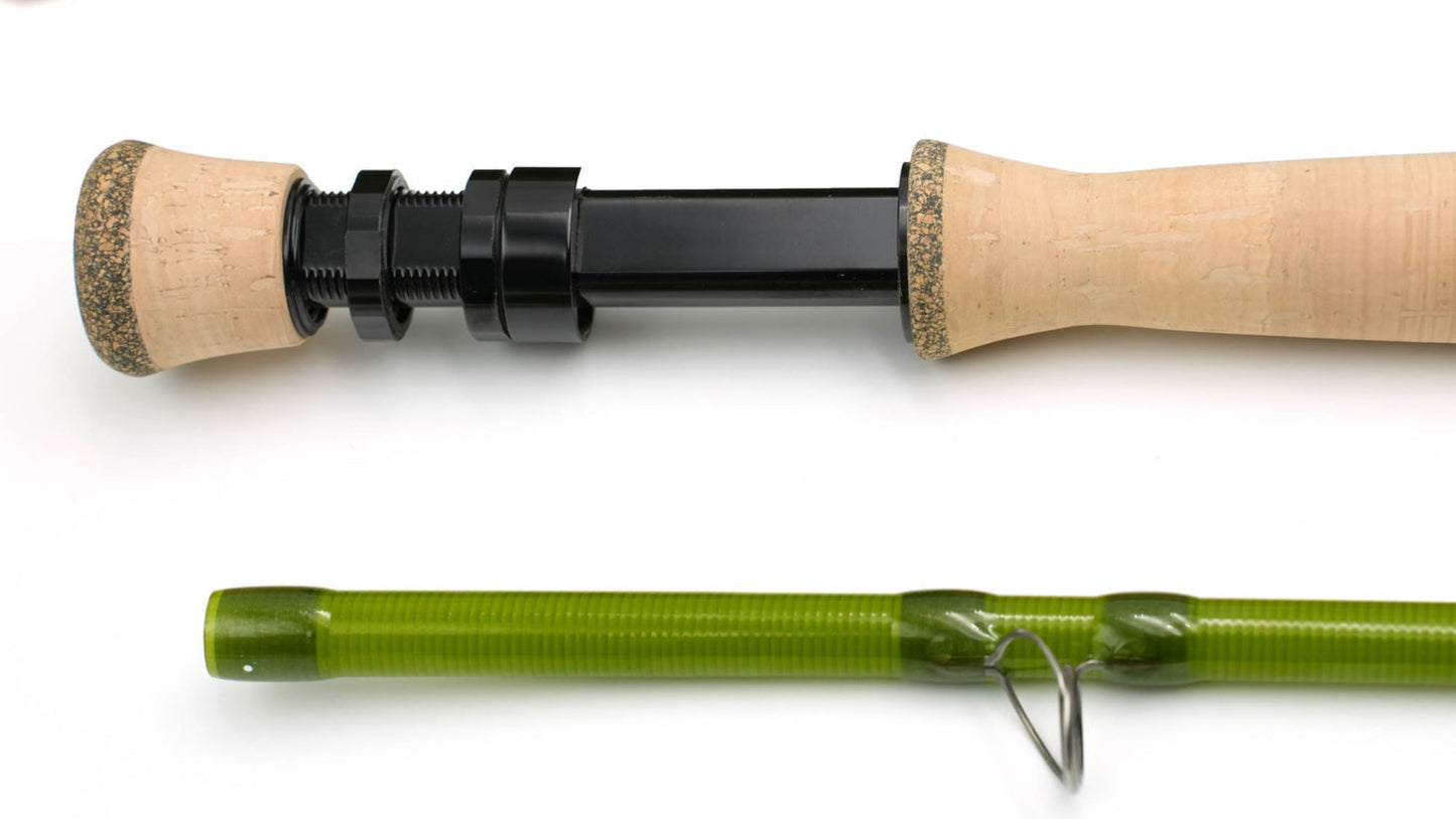 Fishing rod with green handle and cork grips on a white background