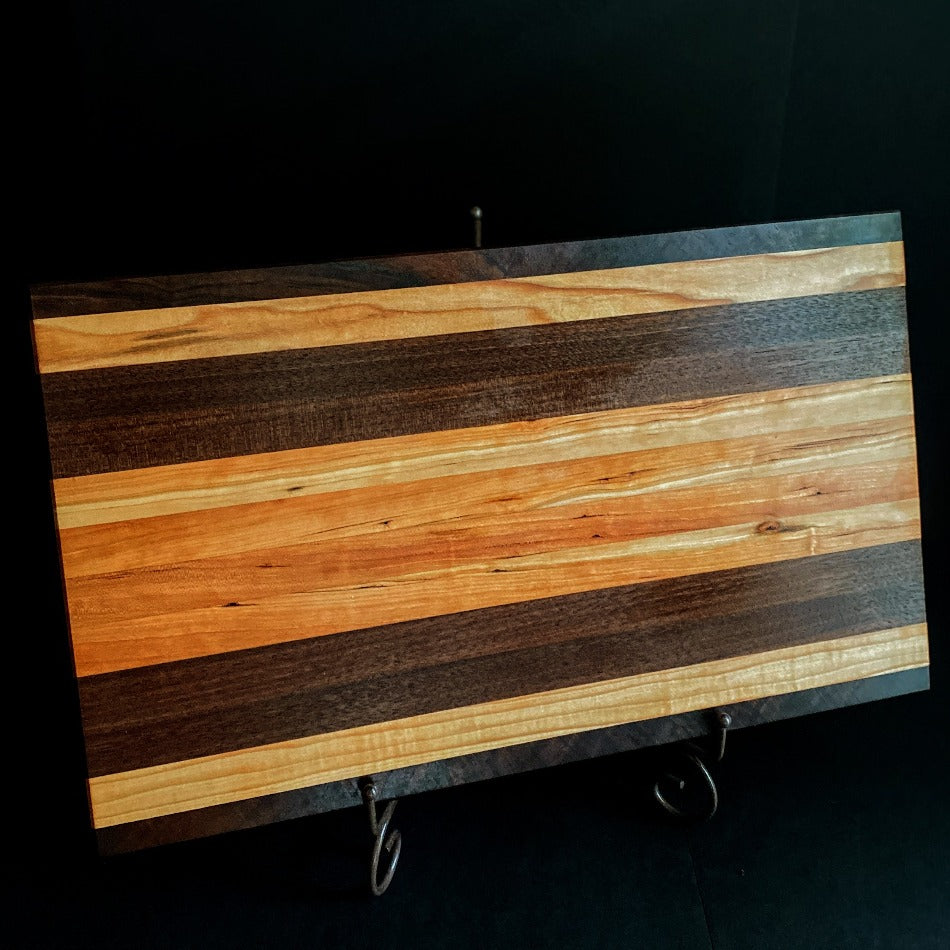Simple and beautiful. This edge grain serving board is just that. Amazing Curly Cherry, Walnut, Tiger Heart Maple and Eastern Highly Figured Walnut resonates with family gatherings all year round, particularly this time of the year. Sutherland Welles Millie's All-Purpose Penetrating Tung Oil highlighted the artistic characteristics of mother nature.