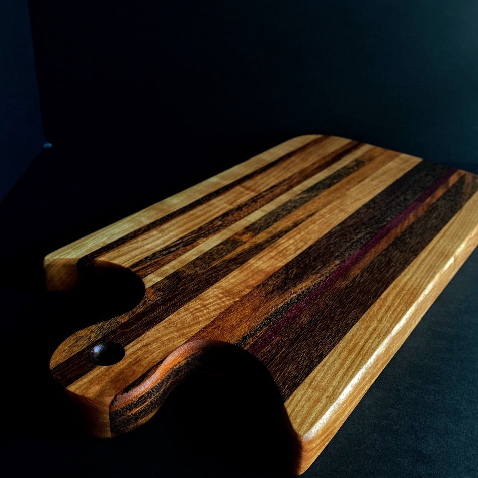 Simple and beautiful. This edge grain serving board is just that. Amazing Curly Cherry, Walnut, Tiger Heart Maple and Eastern Highly Figured Walnut resonates with family gatherings all year round, particularly this time of the year.