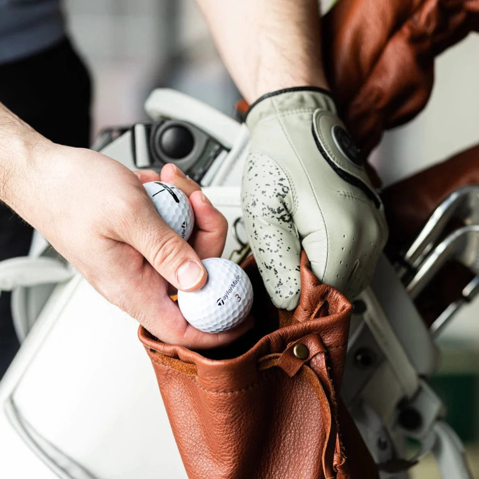 
                  
                    Handcrafted with pebbled leather and a drawcord closure, this golf pouch is the ideal spot to stash all your golfing goodies. Tuck away golf balls, tees, or whatever other teeny treasures you wanna keep close at hand. Problem solved!
                  
                