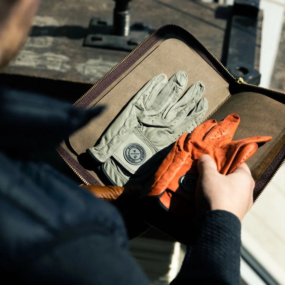 
                      
                        Keep your gloves organized, protected, and in top condition for your next game. Our leather golf glove holder stores gloves of any size with its convenient interior dividers and, with four compartments, there’s space for multiple gloves. Use the exterior zippered pocket to hold small items like ball markers, additional tees, or a divot tool. With the Golf Glove Caddy, you can be sure you have access to the right glove for any shot. 
                      
                    