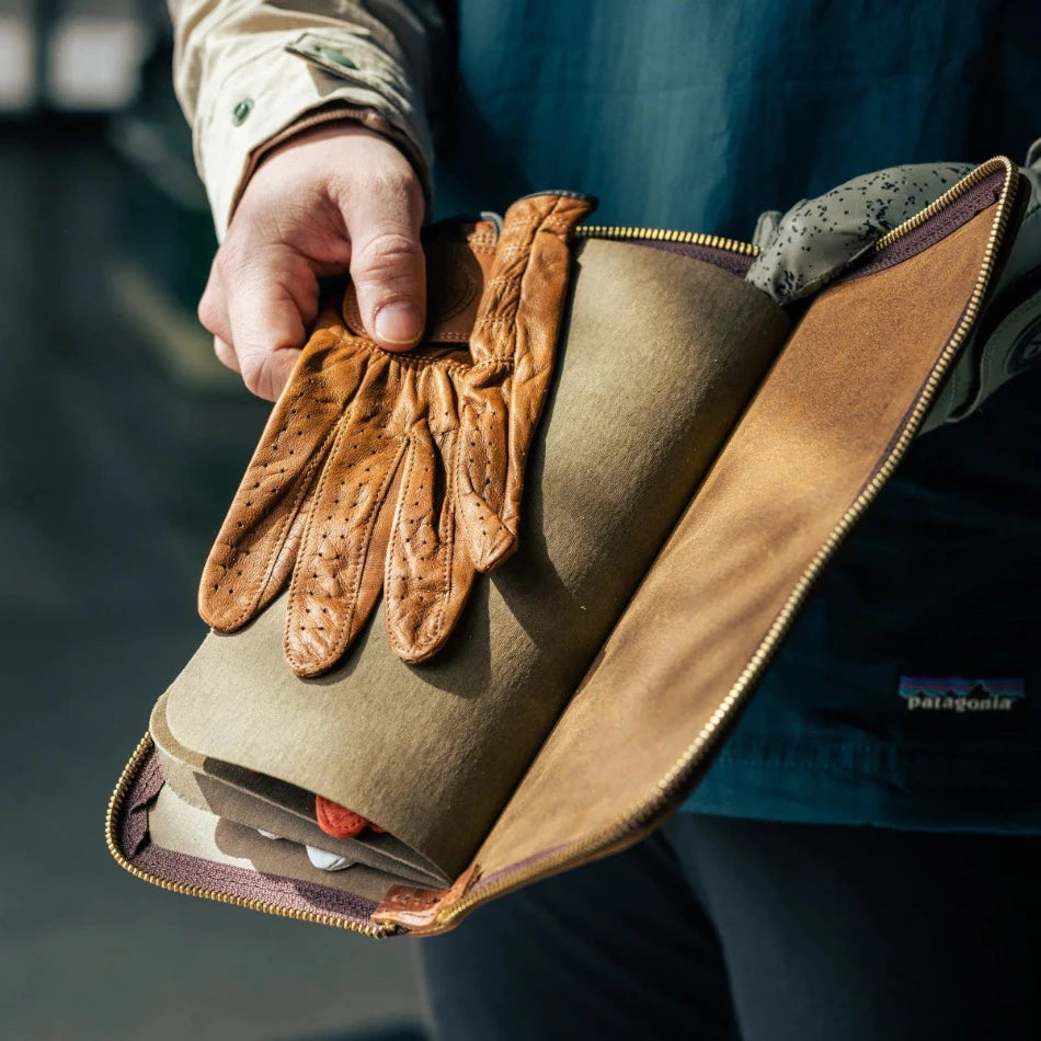 Keep your gloves organized, protected, and in top condition for your next game. Our leather golf glove holder stores gloves of any size with its convenient interior dividers and, with four compartments, there’s space for multiple gloves. Use the exterior zippered pocket to hold small items like ball markers, additional tees, or a divot tool. With the Golf Glove Caddy, you can be sure you have access to the right glove for any shot. 