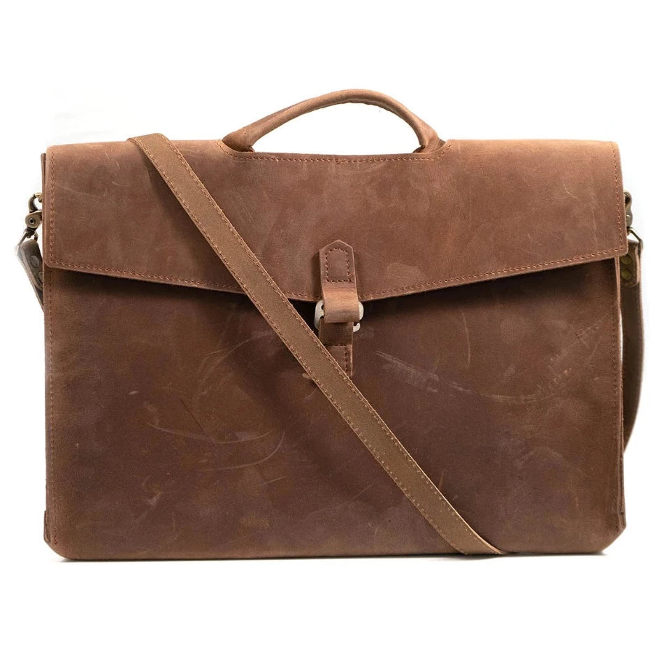 
                  
                    Diplomat Leather Attache The Diplomat Attaché functions as a carry tool for a laptop, wallet, cell phone, and all your other accessories. It can be carried at your side by its reinforced leather handle or cross-body with the included shoulder strap for a sleek appearance. The top grain leather will keep your gear well protected while looking better over time.
                  
                