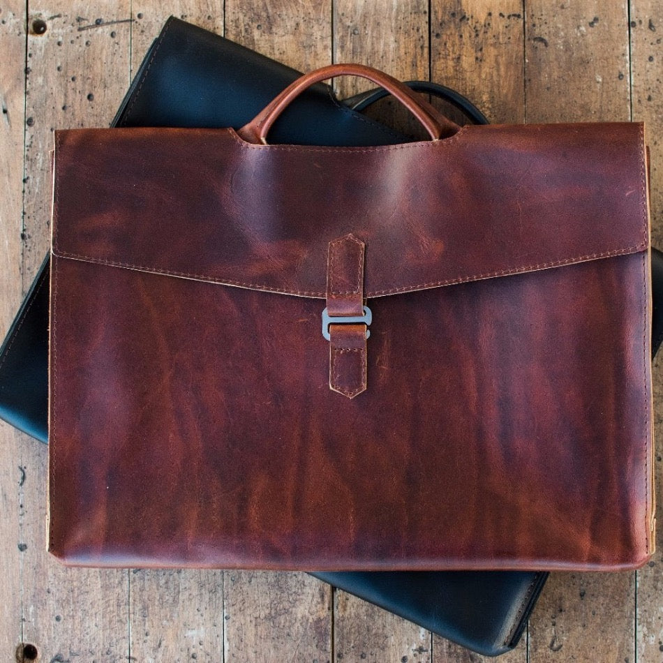 The Diplomat Attaché functions as a carry tool for a laptop, wallet, cell phone, and all your other accessories. It can be carried at your side by its reinforced leather handle or cross-body with the included shoulder strap for a sleek appearance. The top grain leather will keep your gear well protected while looking better over time.