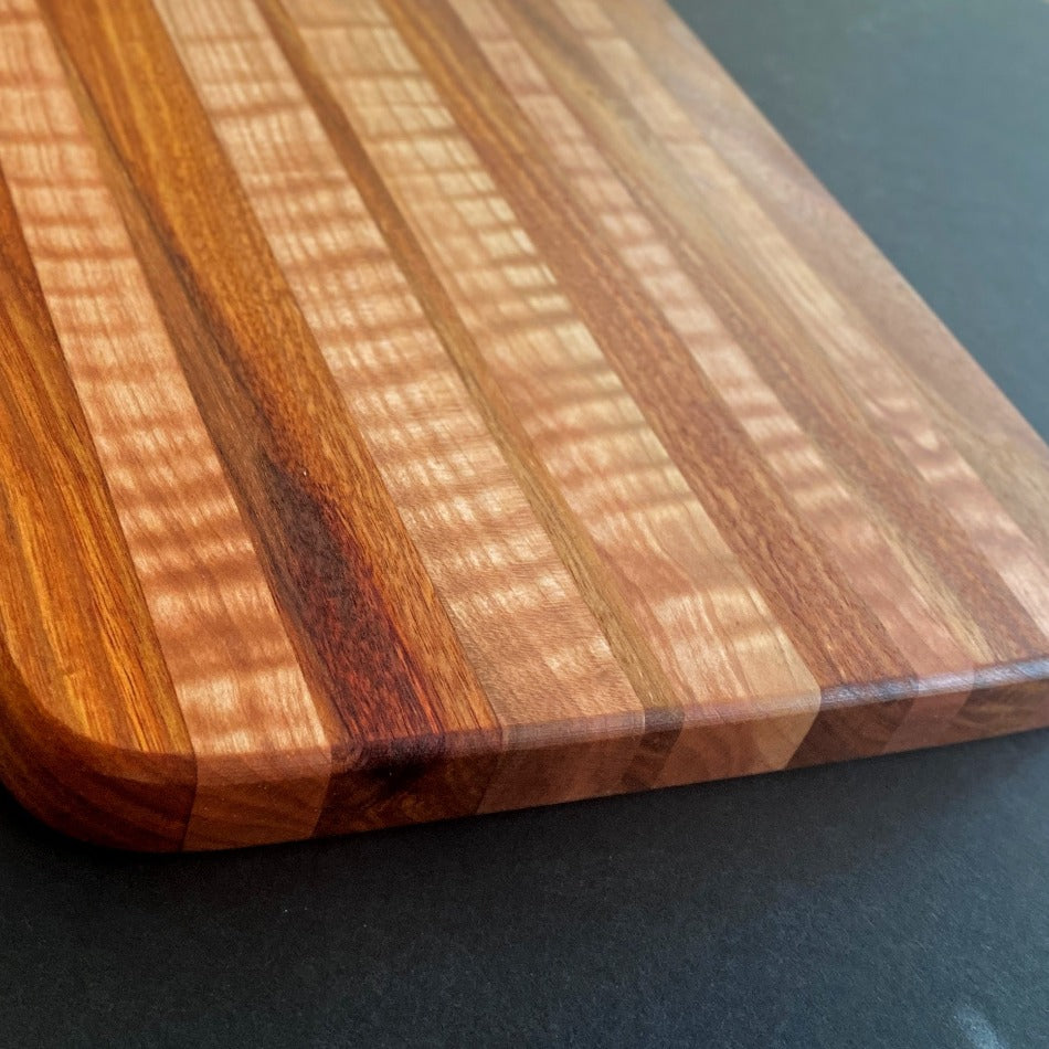 
                  
                    The Handcrafted Charcuterie Board or Bread Board is crafted from Tiger Maple and Canary Wood, measuring 18 x 8 x 1. This combination of woods offers remarkable depth. It is then seasoned with Milie's Tung Oil.
                  
                