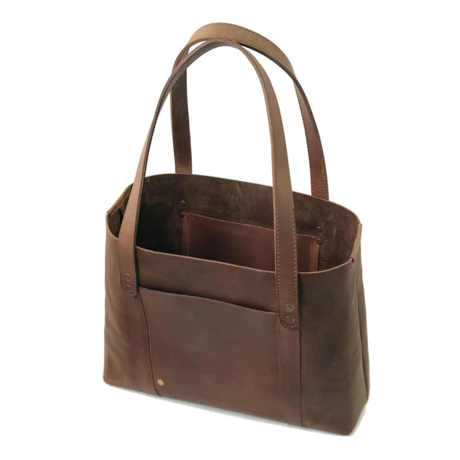 
                  
                    Inspired by cozy mountain cabins and breezy tropical bungalows, the Hideout Leather Tote confidently stows blankets and novels or sandals and yoga mats. Handcrafted with large pockets flat lather handles and a wide-open top, this gorgeous piece is the perfect bag for anywhere life takes you.
                  
                