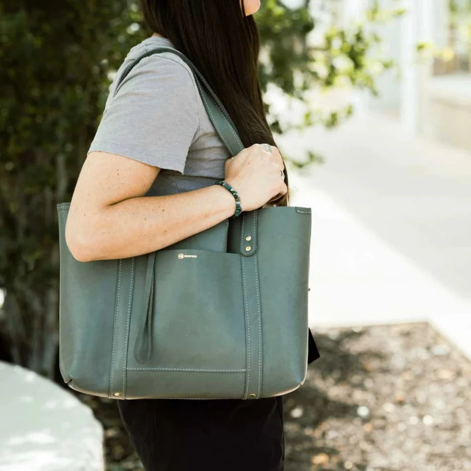 Inspired by cozy mountain cabins and breezy tropical bungalows, the Hideout Leather Tote confidently stows blankets and novels or sandals and yoga mats. Handcrafted with large pockets flat lather handles and a wide-open top, this gorgeous piece is the perfect bag for anywhere life takes you.
