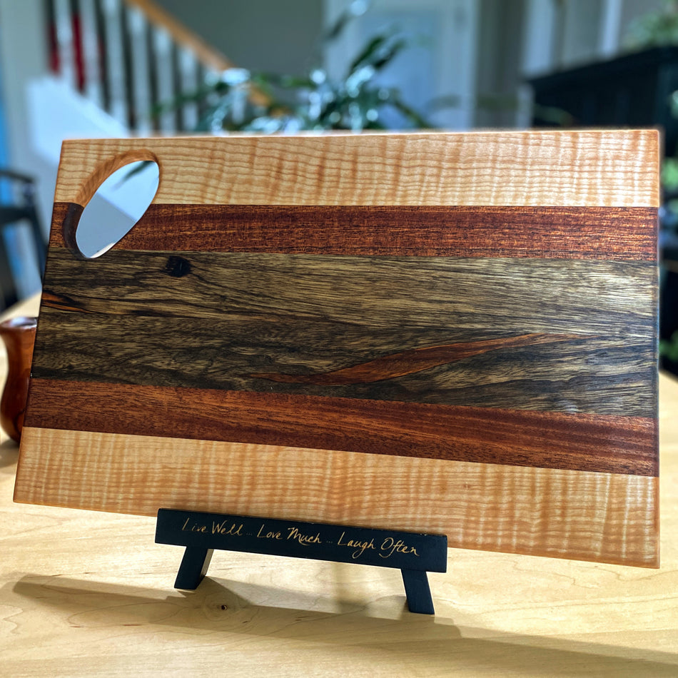
                  
                    Observe the exquisite combination of Black Limba, Jatoba and Curly Birch, a marriage of wood hues and textures. Gaze at the golden-brown of the Black Limba that pairs so perfectly with the similar shade of the Jatoba. The Black Limba strips were cut and arranged with intention to pair with the Jatoba.
                  
                