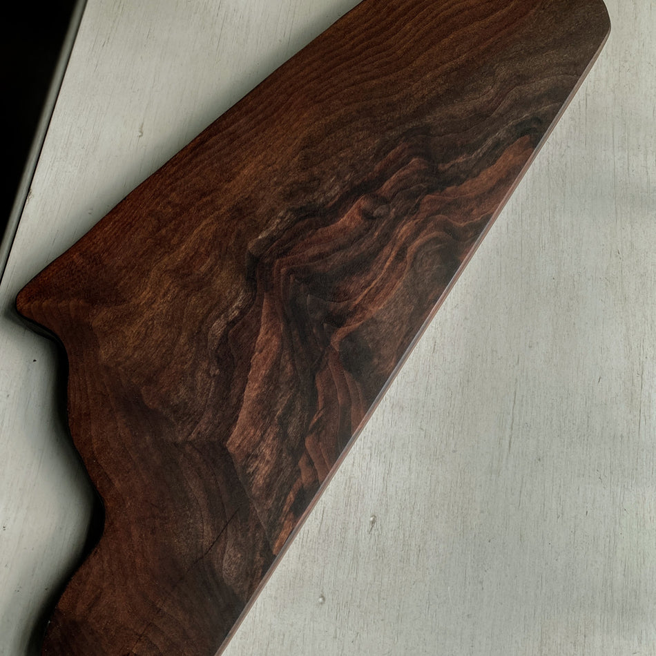 This 22"x10"x1" Charcuterie Board is crafted from Claro Walnut Live Edge and finished with Sutherland Welles Tung Oil. It makes an ideal centerpiece for any table.