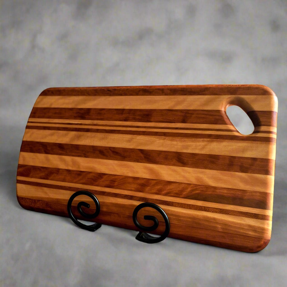 This Charcuterie Board is crafted from Curly Cherry and Tiger Heart. These two wood species are beautiful together. cutting surface. The 17 3/4-inch board delivers ample space to hold meats, cheeses, fruits, and other appetizers, while the 1-inch thickness offers durable rigidity. A Millie's All-Purpose Penetrating Tung Oil finish seals to further reinforce the board's strength and longevity.