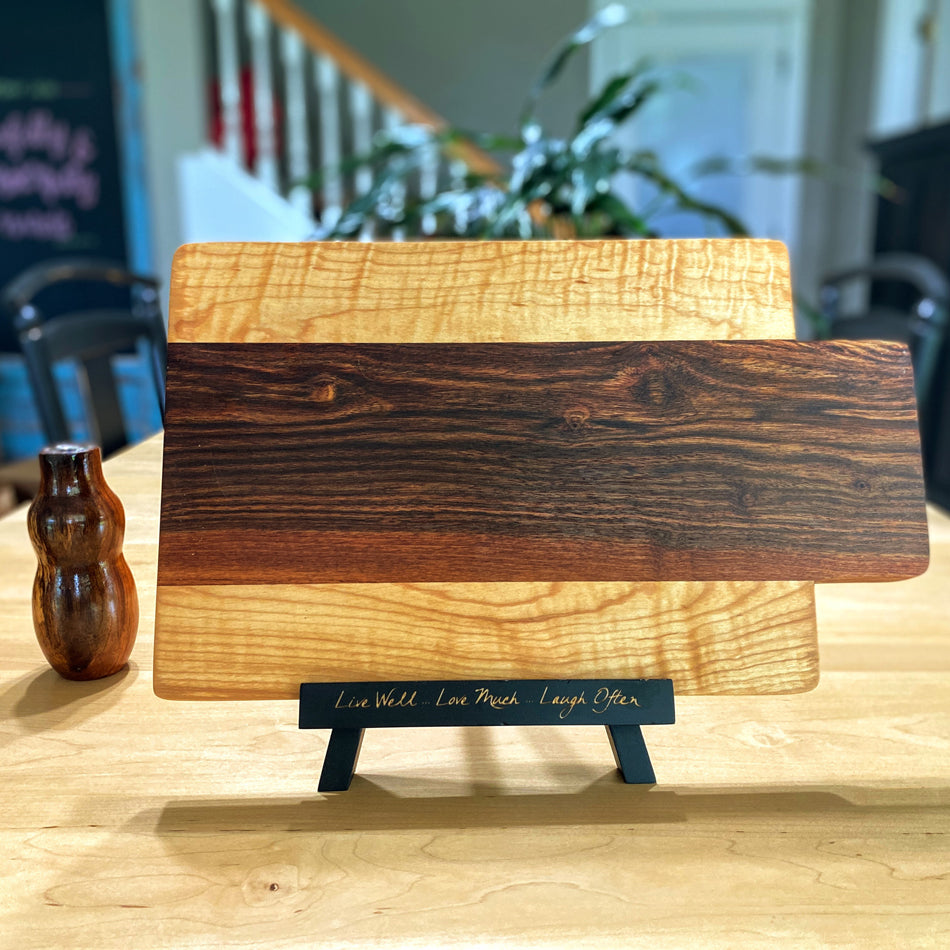 
                  
                    This remarkable Charcuterie Board is handmade with Caribbean Rosewood and Curly Birchwood. These exquisite woods create a stunning color combination, perfect for patio evenings with cocktails and sushi. This board is double-sided and offers an ideal size for crafting delightful charcuterie spreads.
                  
                