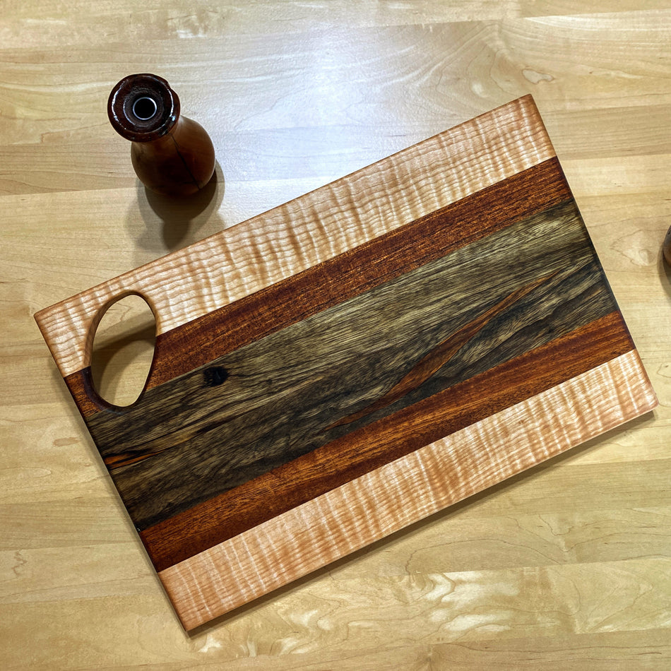 Observe the exquisite combination of Black Limba, Jatoba and Curly Birch, a marriage of wood hues and textures. Gaze at the golden-brown of the Black Limba that pairs so perfectly with the similar shade of the Jatoba. The Black Limba strips were cut and arranged with intention to pair with the Jatoba.