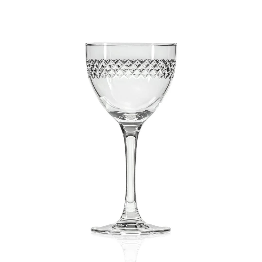 Diamond Nic & Nora cocktail glass with amber spirit, cut-crystal pattern detai