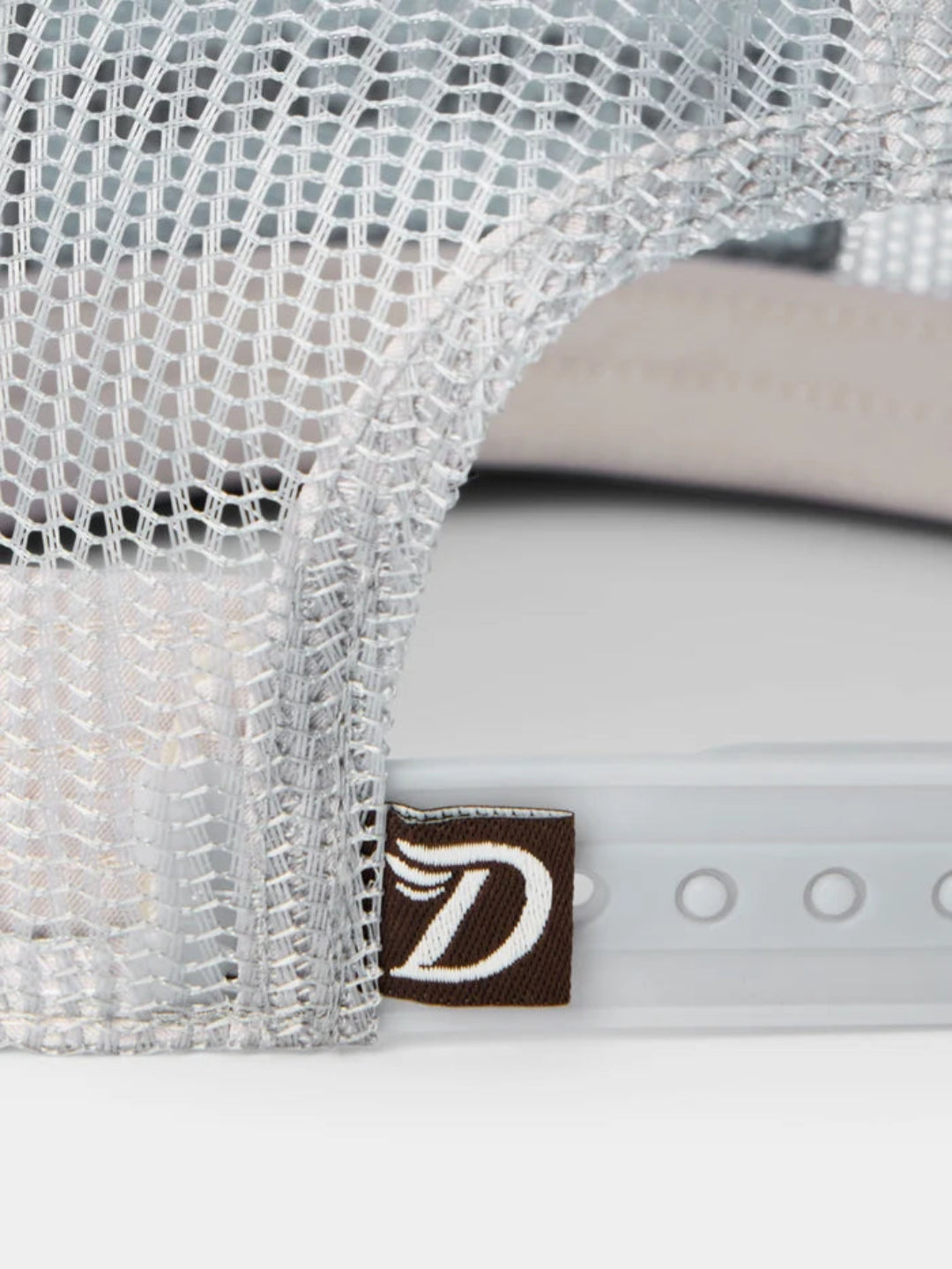 Close-up of a cap with a mesh back and a brand logo on a white background